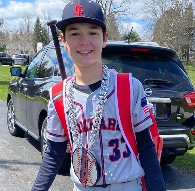 Athlete wearing a custom swag chain with team branding.