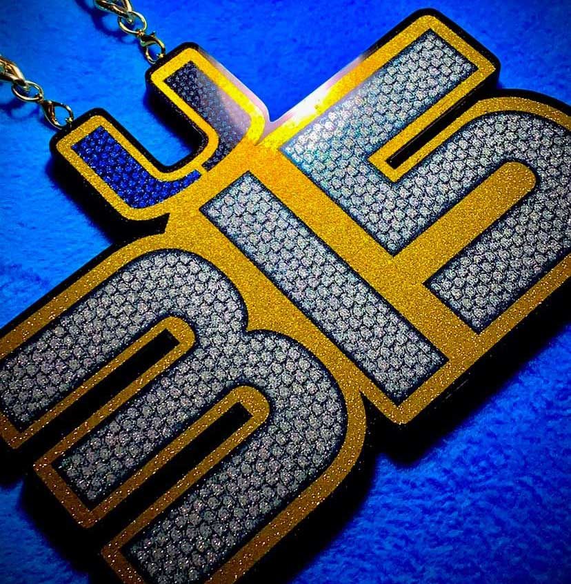 Team turnover chain pendant with metallic flake finish.