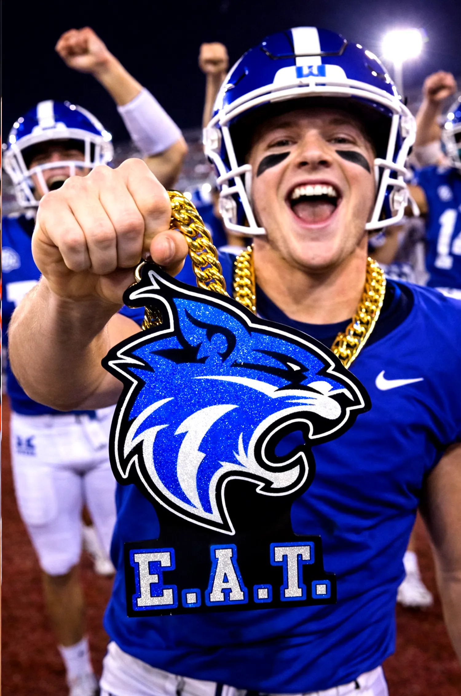 Football player wearing the Eat Wildcats pendant.