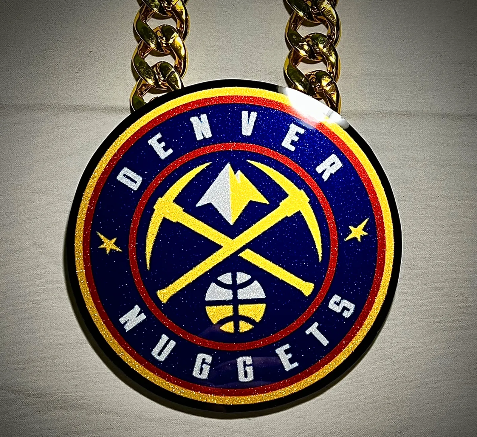 Round basketball pendant in Denver team colors.