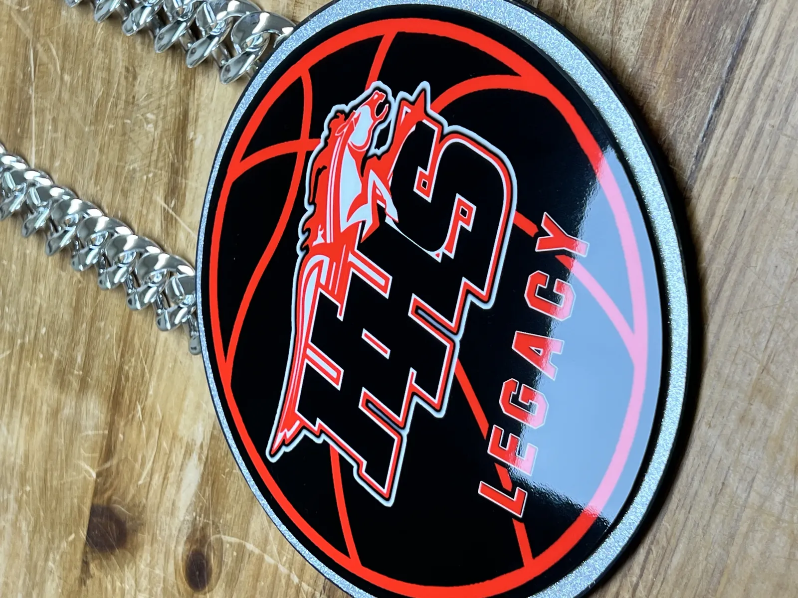 Close-up of a THS Legacy basketball pendant.