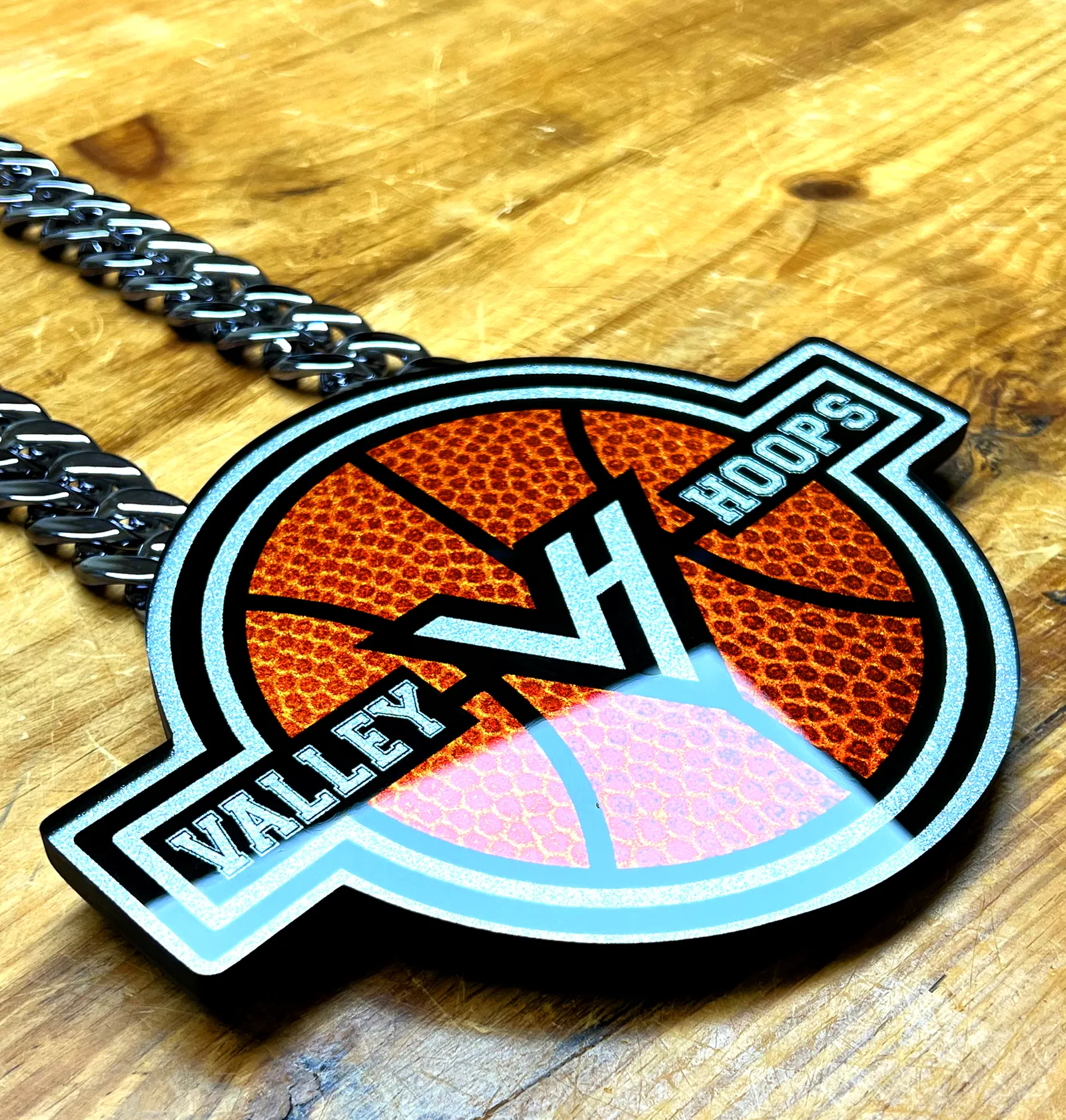 Valley Hoops VH pendant from an angled view.