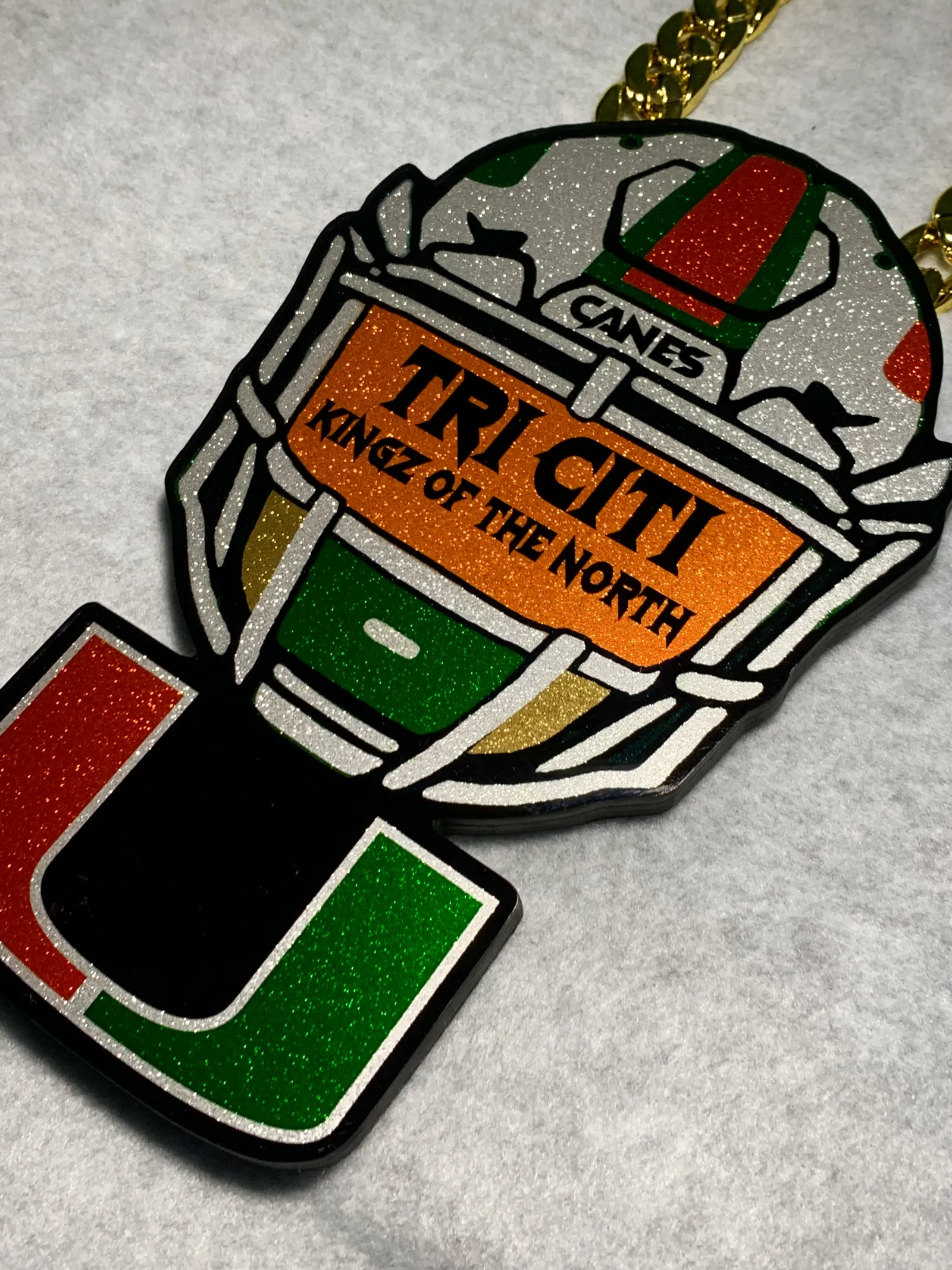 Miami Hurricanes style football turnover chain pendant.
